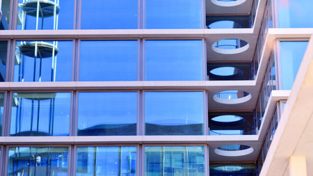 Downtown corporate business district architecture. Glass reflective office buildings against blue sky and sun light. Economy, finance, business activity concept. Rising sun on theの写真素材