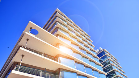 Downtown corporate business district architecture. Glass reflective office buildings against blue sky and sun light. Economy, finance, business activity concept. Rising sun on theの写真素材