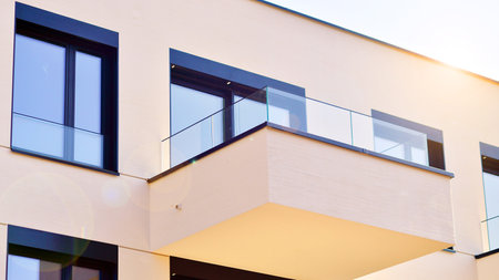 Modern architecture of urban residential apartment buildings on a sunny day. Low-rise apartment buildings with large windows and extensive terraces. White facade of a modern apartmentの写真素材