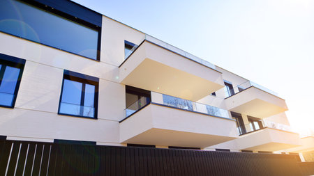 Modern architecture of urban residential apartment buildings on a sunny day. Low-rise apartment buildings with large windows and extensive terraces. White facade of a modern apartmentの写真素材