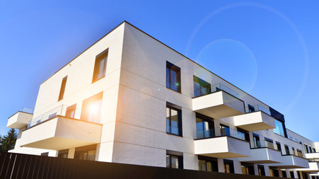 Modern architecture of urban residential apartment buildings on a sunny day. Low-rise apartment buildings with large windows and extensive terraces. White facade of a modern apartmentの写真素材