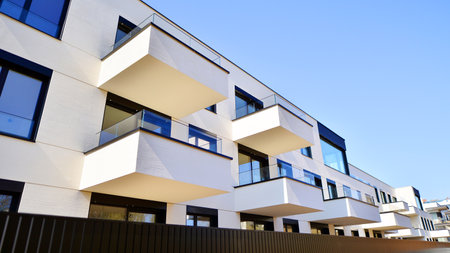 Modern architecture of urban residential apartment buildings on a sunny day. Low-rise apartment buildings with large windows and extensive terraces. White facade of a modern apartmentの写真素材