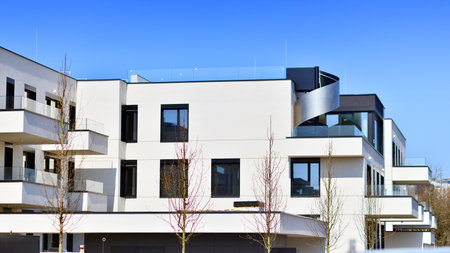 Modern architecture of urban residential apartment buildings on a sunny day. Low-rise apartment buildings with large windows and extensive terraces. White facade of a modern apartmentの写真素材