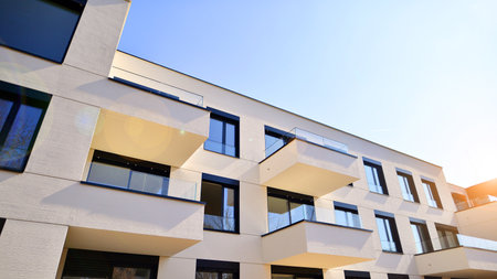Modern architecture of urban residential apartment buildings on a sunny day. Low-rise apartment buildings with large windows and extensive terraces. White facade of a modern apartmentの写真素材