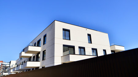 Modern architecture of urban residential apartment buildings on a sunny day. Low-rise apartment buildings with large windows and extensive terraces. White facade of a modern apartmentの写真素材