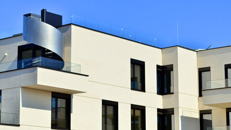 Modern architecture of urban residential apartment buildings on a sunny day. Low-rise apartment buildings with large windows and extensive terraces. White facade of a modern apartmentの写真素材