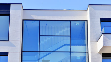 Modern architecture of urban residential apartment buildings on a sunny day. Low-rise apartment buildings with large windows and extensive terraces. White facade of a modern apartmentの写真素材