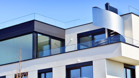 Modern architecture of urban residential apartment buildings on a sunny day. Low-rise apartment buildings with large windows and extensive terraces. White facade of a modern apartmentの写真素材
