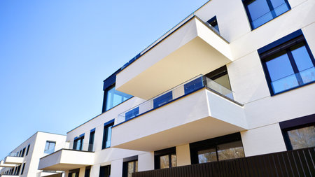 Modern architecture of urban residential apartment buildings on a sunny day. Low-rise apartment buildings with large windows and extensive terraces. White facade of a modern apartmentの写真素材