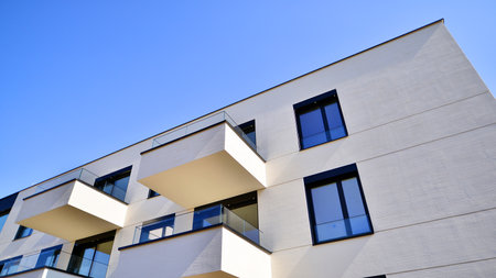 Modern architecture of urban residential apartment buildings on a sunny day. Low-rise apartment buildings with large windows and extensive terraces. White facade of a modern apartmentの写真素材