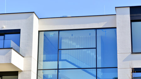 Modern architecture of urban residential apartment buildings on a sunny day. Low-rise apartment buildings with large windows and extensive terraces. White facade of a modern apartmentの写真素材