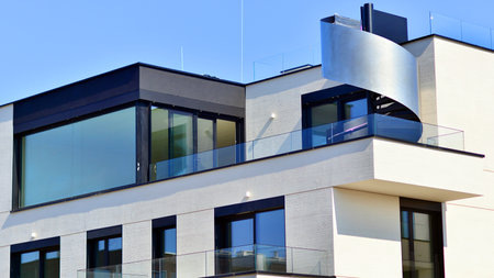 Modern architecture of urban residential apartment buildings on a sunny day. Low-rise apartment buildings with large windows and extensive terraces. White facade of a modern apartmentの写真素材