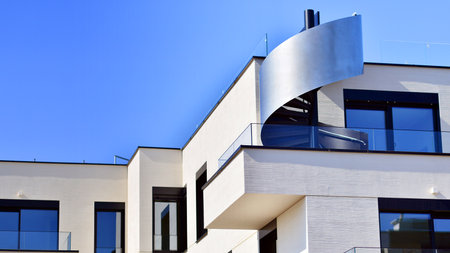 Modern architecture of urban residential apartment buildings on a sunny day. Low-rise apartment buildings with large windows and extensive terraces. White facade of a modern apartmentの写真素材