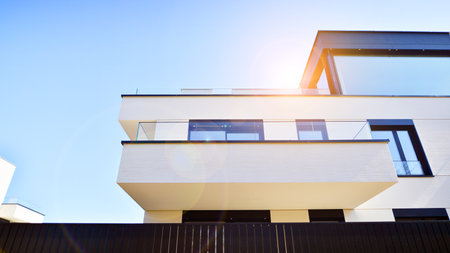 Modern architecture of urban residential apartment buildings on a sunny day. Low-rise apartment buildings with large windows and extensive terraces. White facade of a modern apartmentの写真素材