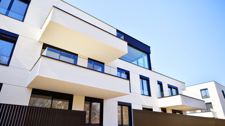 Modern architecture of urban residential apartment buildings on a sunny day. Low-rise apartment buildings with large windows and extensive terraces. White facade of a modern apartmentの写真素材