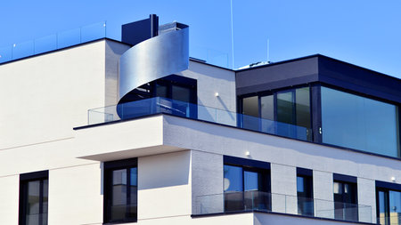 Modern architecture of urban residential apartment buildings on a sunny day. Low-rise apartment buildings with large windows and extensive terraces. White facade of a modern apartmentの写真素材