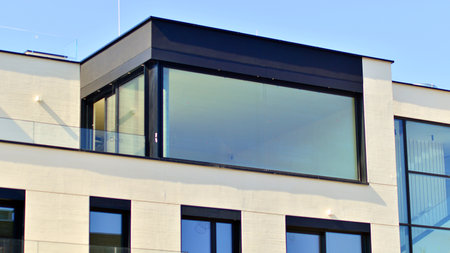 Modern architecture of urban residential apartment buildings on a sunny day. Low-rise apartment buildings with large windows and extensive terraces. White facade of a modern apartmentの写真素材
