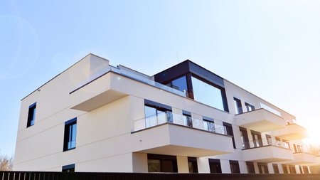 Modern architecture of urban residential apartment buildings on a sunny day. Low-rise apartment buildings with large windows and extensive terraces. White facade of a modern apartmentの写真素材