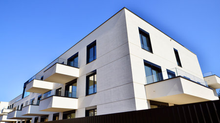 Modern architecture of urban residential apartment buildings on a sunny day. Low-rise apartment buildings with large windows and extensive terraces. White facade of a modern apartmentの写真素材