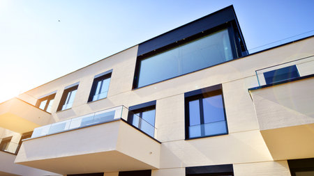 Modern architecture of urban residential apartment buildings on a sunny day. Low-rise apartment buildings with large windows and extensive terraces. White facade of a modern apartmentの写真素材