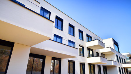 Modern architecture of urban residential apartment buildings on a sunny day. Low-rise apartment buildings with large windows and extensive terraces. White facade of a modern apartmentの写真素材