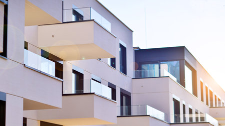 Modern architecture of urban residential apartment buildings on a sunny day. Low-rise apartment buildings with large windows and extensive terraces. White facade of a modern apartmentの写真素材