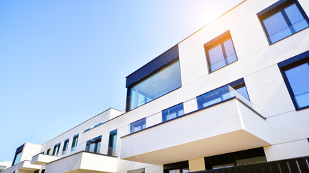 Modern architecture of urban residential apartment buildings on a sunny day. Low-rise apartment buildings with large windows and extensive terraces. White facade of a modern apartmentの写真素材