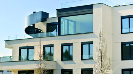 Modern architecture of urban residential apartment buildings on a sunny day. Low-rise apartment buildings with large windows and extensive terraces. White facade of a modern apartmentの写真素材