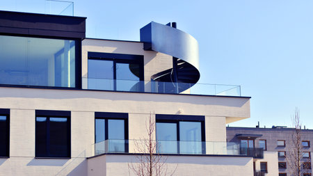 Modern architecture of urban residential apartment buildings on a sunny day. Low-rise apartment buildings with large windows and extensive terraces. White facade of a modern apartmentの写真素材