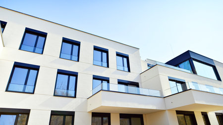 Modern architecture of urban residential apartment buildings on a sunny day. Low-rise apartment buildings with large windows and extensive terraces. White facade of a modern apartmentの写真素材