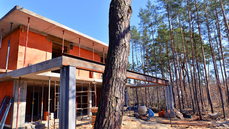 A suburban district of single-family homes. Single family house construction site. Modern designed single-family house under construction.の写真素材