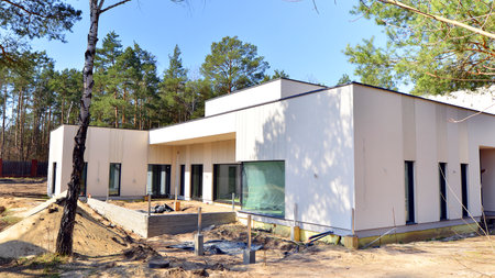 A suburban district of single-family homes. Single family house construction site. Modern designed single-family house under construction.の写真素材