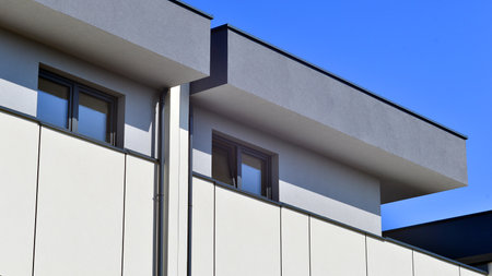 Terraced family homes in newly developed housing estate. The real estate market in the suburbs. New single family houses in a new development area. Residential homes with modern faの写真素材