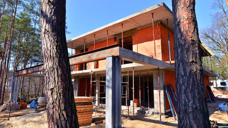 A suburban district of single-family homes. Single family house construction site. Modern designed single-family house under construction.の写真素材