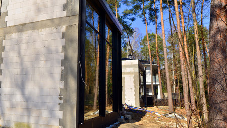 A suburban district of single-family homes. Single family house construction site. Modern designed single-family house under construction.の写真素材