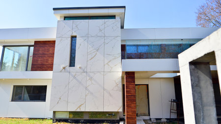 A suburban district of single-family homes. Single family house construction site. Modern designed single-family house under construction.の写真素材