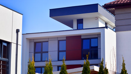 Terraced family homes in newly developed housing estate. The real estate market in the suburbs. New single family houses in a new development area. Residential homes with modern faの写真素材
