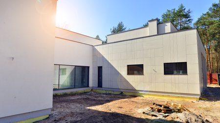 A suburban district of single-family homes. Single family house construction site. Modern designed single-family house under construction.の写真素材