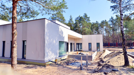 A suburban district of single-family homes. Single family house construction site. Modern designed single-family house under construction.の写真素材