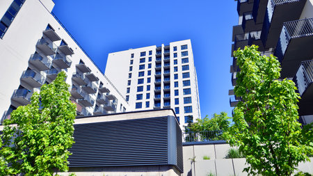 Eco apartment building saving energy and fresh air. Modern block of flats in green area, residential apartment and luxury house complex.の写真素材