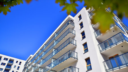 Eco apartment building saving energy and fresh air. Modern block of flats in green area, residential apartment and luxury house complex.の写真素材