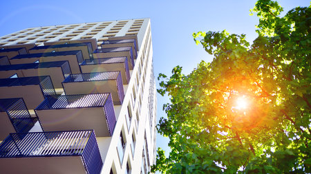 Eco apartment building saving energy and fresh air. Modern block of flats in green area, residential apartment and luxury house complex.の写真素材