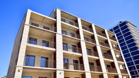 Modern new residential apartment house building complex. Exterior view of modern apartment building. New construction apartment or condo complex.の写真素材