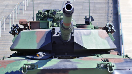 Heavy military tank vehicle turret gun aiming on a target and ready to fire. The rotating turret...