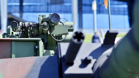 Heavy military tank vehicle turret gun aiming on a target and ready to fire. The rotating turret...