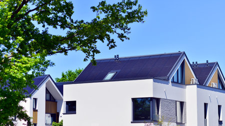 Residential homes with modern facade. Terraced family homes in newly developed housing estate. The real estate market in the suburbs. New single family houses in a new developmentの写真素材