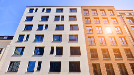 Modern apartment buildings on a sunny day with a blue sky. Facade of a modern apartment building....