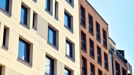 Modern apartment buildings on a sunny day with a blue sky. Facade of a modern apartment building. Modern residential apartment building complex condo.の写真素材