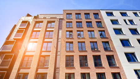 Modern apartment buildings on a sunny day with a blue sky. Facade of a modern apartment building....