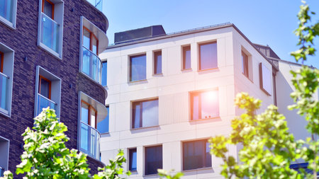 New modern block of flats in green area. complex. New modern block of flats in green area. European residential architecture harmonizing with nature. Eco-friendly living in city wiの写真素材